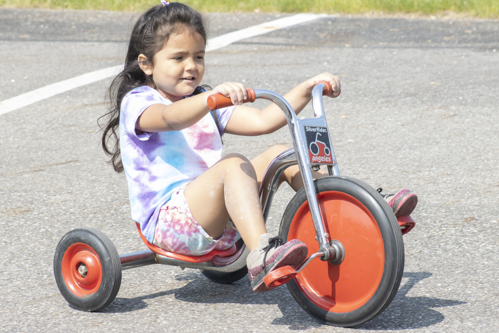 aels student riding a trike