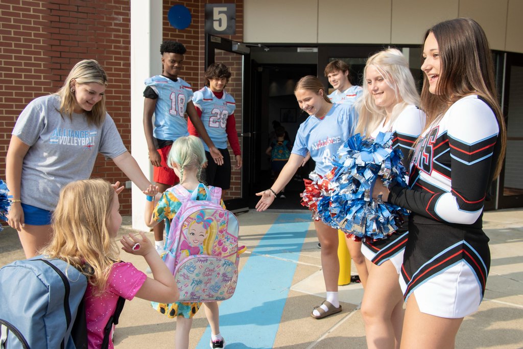 Athletes welcoming students to school